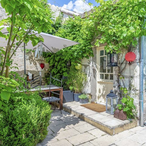 Dine alfresco on the terrace, surrounded by climbing leaves and vibrant nature