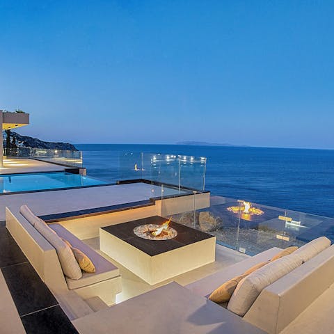 Gather around the fire pit with a glass of wine in hand as the sun sets