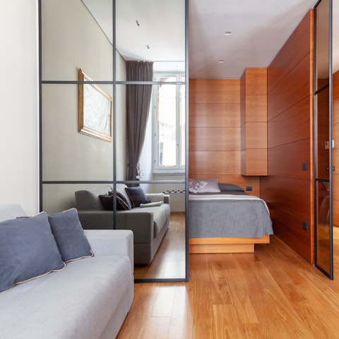 Slide open the mirrored doors to reveal the wood-framed sleeping nook