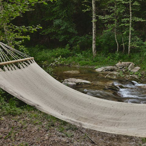 Listen to the peaceful sound of the river while relaxing in the hammock