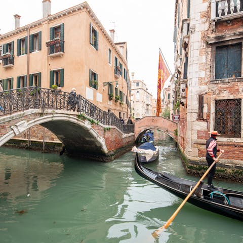 Watch gondoliers navigate the canal through the window