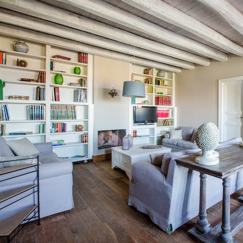 Retreat from the heat with one of the many books on the living room's shelves