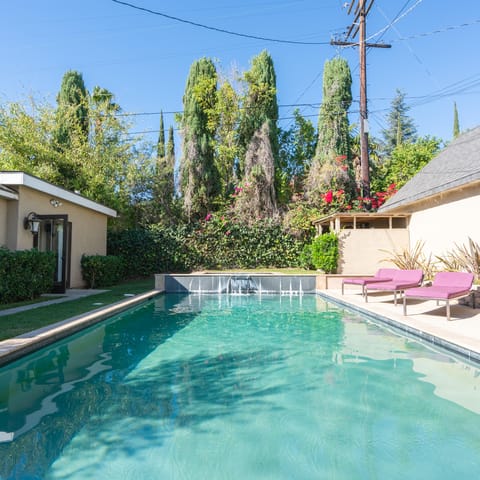 Take the plunge in your aquamarine pool with waterfall fountains