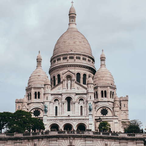 Visit the Sacré-Cœur at the top of the hill, an eight-minute walk from home