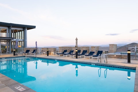 Swim in the shared pool as the last light fades over the distant peaks