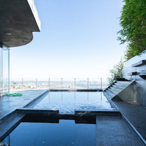 Swim each morning in the home's pool with epic views