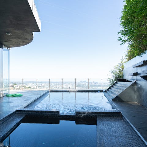 Swim each morning in the home's pool with epic views