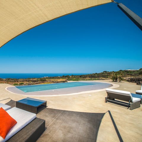 Swim in your infinity pool overlooking the sea and greenery