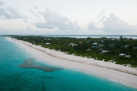 Explore Long Bay Beach's turquoise shallows, perfect for kitesurfing and paddleboarding