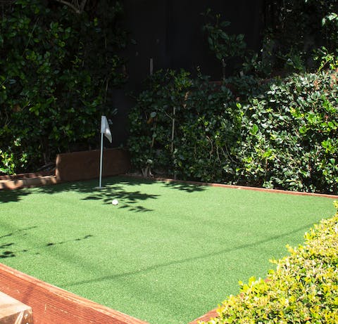 Hone your putting on the mini green at the side of the home