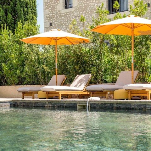 Cool off in the outdoor pool or unwind on a lounger