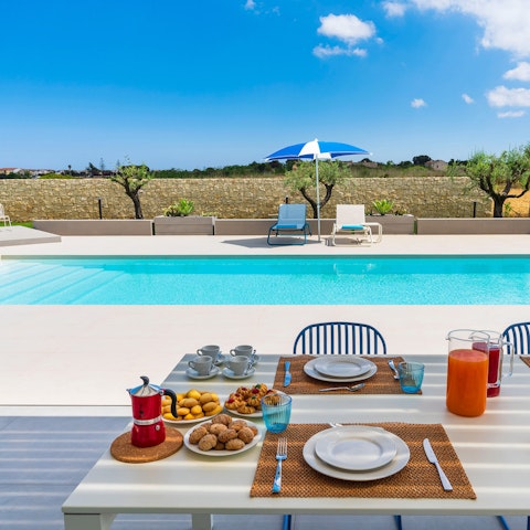 Dine on fresh Italian pastries and blood orange juice while gazing at turquoise water