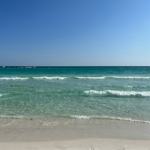 Sink your toes into the soft sand of Miramar Beach, right on your doorstep