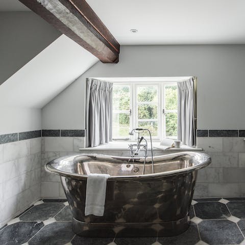 Soak in the striking, silver roll-top bath