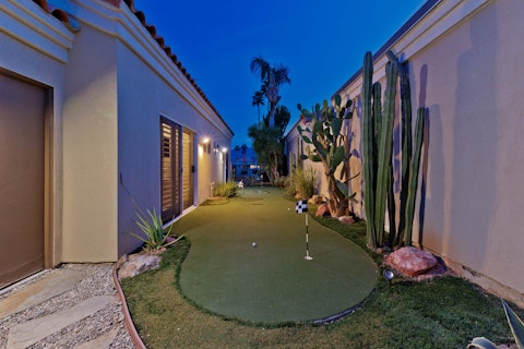 Practise your short game surrounded by desert landscaping at dusk