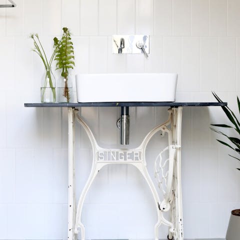 Fall in love with the unique touches, like the upcycled Singer sewing machine used as a sink