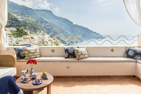 Sip your morning espresso while gazing at Positano's clifftops and harbour