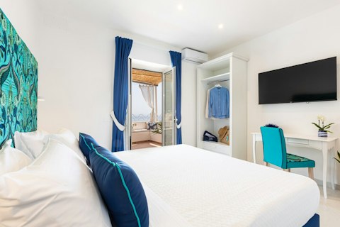 Wake in crisp white sheets with your private terrace steps away