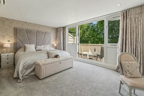 Step out onto the private balcony with leafy views