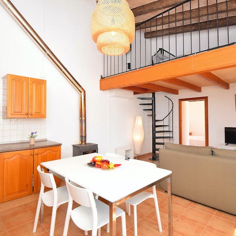 Relax in this bright living space, where a spiral staircase leads you to the mezzanine level