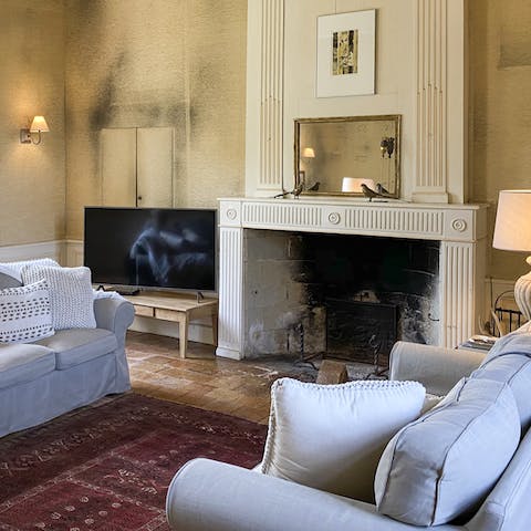 Curl up infront of the original fireplace in the living room