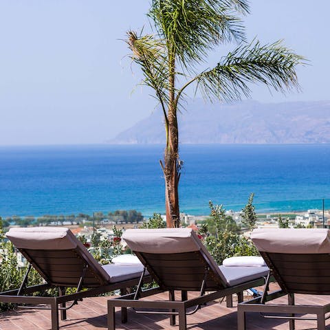 Sunbathe before the panoramic sea of blue on the private terrace