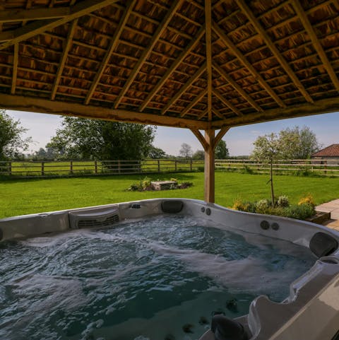 Take in the views over the fields from the hot tub