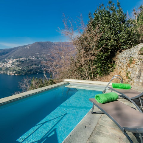 Relax by the pool while taking in the stunning lake view