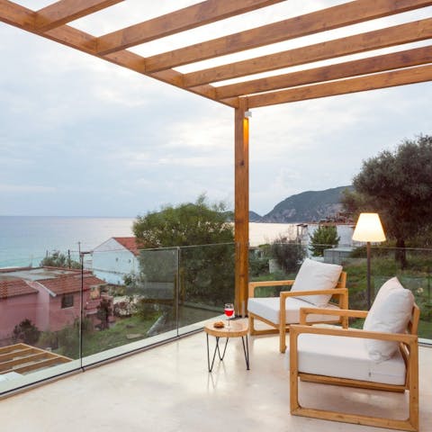 Sip wine on the terrace as the sun sets over the sea