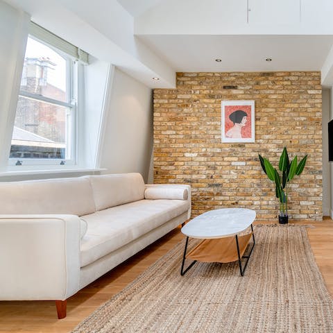 Relax in the stylish living room with a mug of tea and a good book after a busy day of exploring the city