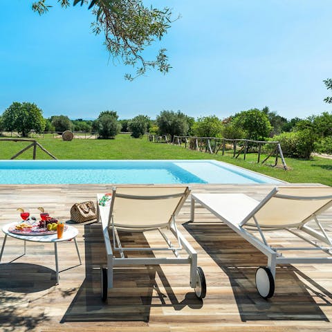 Lounge by the pool overlooking peaceful countryside