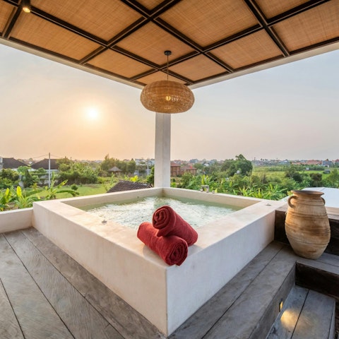Unwind in the rooftop jacuzzi with a view of the rice fields