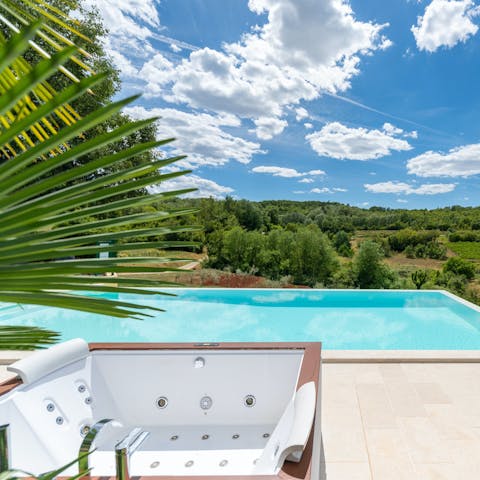 Enjoy countryside views from the private pool and hot tub