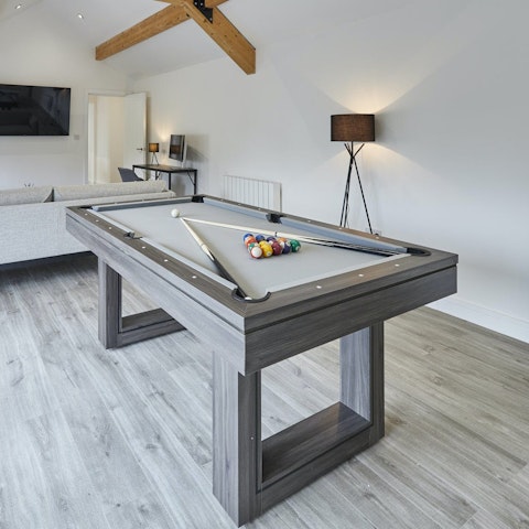 Enjoy a game of pool over a cold glass of beer