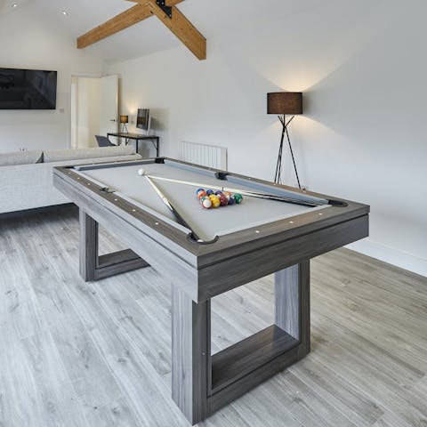 Enjoy a game of pool over a cold glass of beer