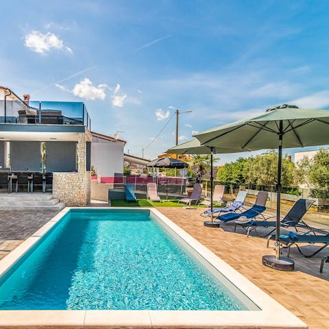 Lounge by the pool and take refreshing dips in its glistening water