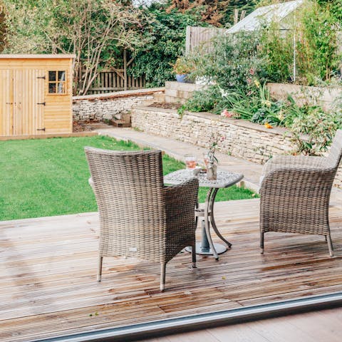 The living room spills into the lush garden