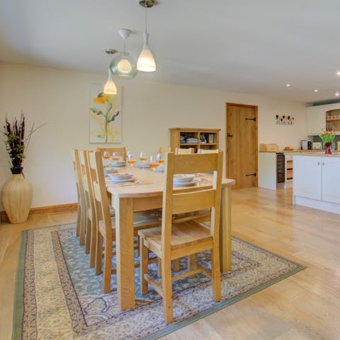 Prepare homecooked meals to be enjoyed around the dining table, with the light fixtures adding an ambience