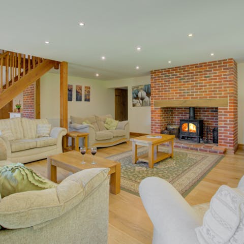 Enjoy cosy evenings in the living room, lounging on the plush sofas while the fireplace warms you up