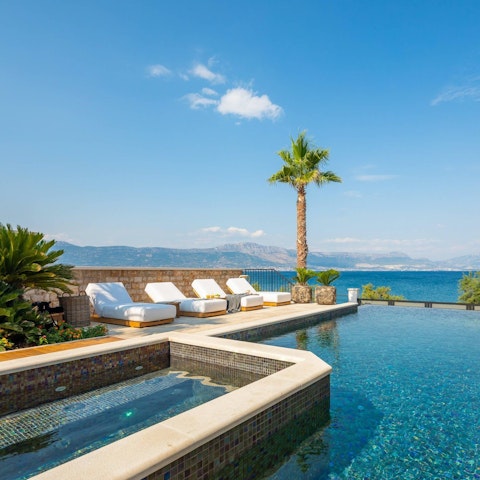 Soak up the sun and sea views from beside the heated pool
