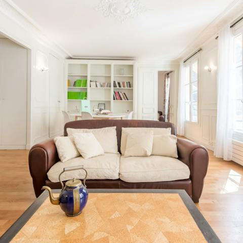 Get comfy on the leather couch and bask in the natural light that streams through the enormous windows
