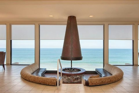 Gather round the circular fireplace in the clubhouse with the ocean as your backdrop
