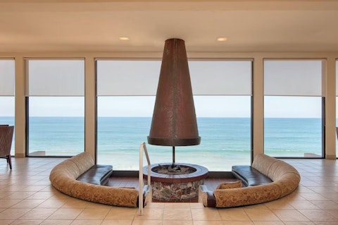 Gather round the circular fireplace in the clubhouse with the ocean as your backdrop