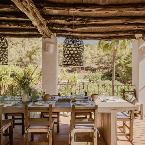 Enjoy the peace of the villa's grounds while dining on the terrace