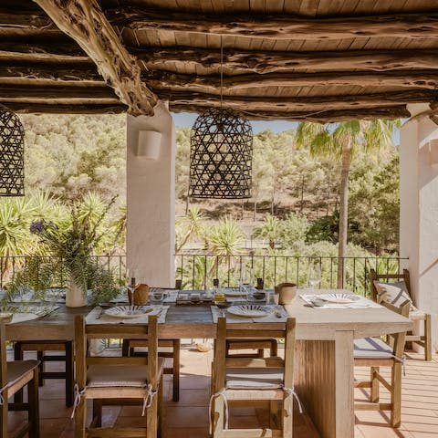 Enjoy the peace of the villa's grounds while dining on the terrace