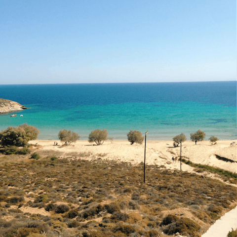 Take a dip in the crystal clear waters at Psarou Beach