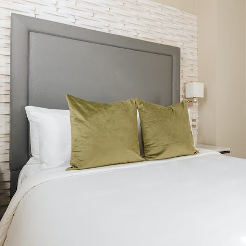 Get some rest in the stylish bedroom with its large headboard