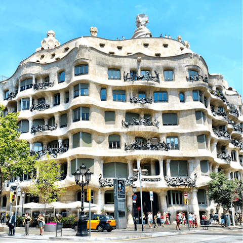 Go out and explore Gaudí's masterpieces in Barcelona like Casa Milà, a fifteen-minute walk away