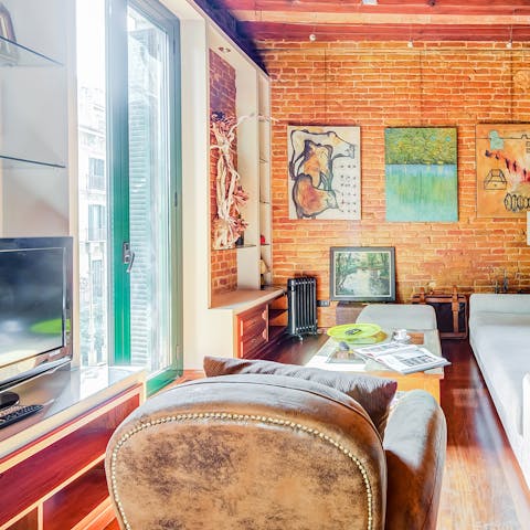 Relax in the chic living room as the sun pours in through the floor-to-ceiling windows