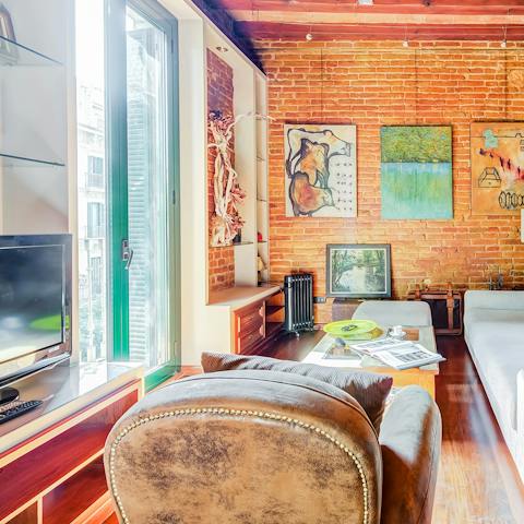 Relax in the chic living room as the sun pours in through the floor-to-ceiling windows